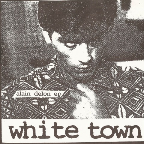 Cover of White Town's Alain Delon EP. It consists of a xeroxed photo of the titular actor, with the name of the EP overlayed on his shoulder and the band name displayed below the photo, on a white background.