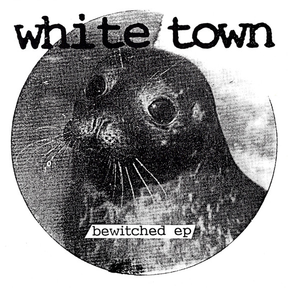 Cover of White Town's Bewitched EP. It consists of a black and white circular photograph of a seal, framed by a white background. The name of the band and EP are overlayed on top of the picture.