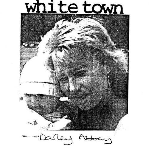 Cover of White Town's Darley Abbey 7-inch flexi-disc single. It consists of a black-and-white close-up photograph of a woman with a melancholic expression on her face, holding a baby by her side. A white border surrounds the image, in which the band's name (in the typewriter font) and the name of the record (handwritten) are contained.